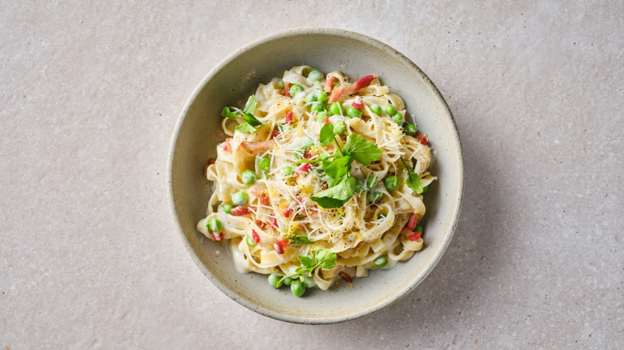 Tagliatelles crémeuses aux petits pois, ail, parmesan et pancetta croustillante